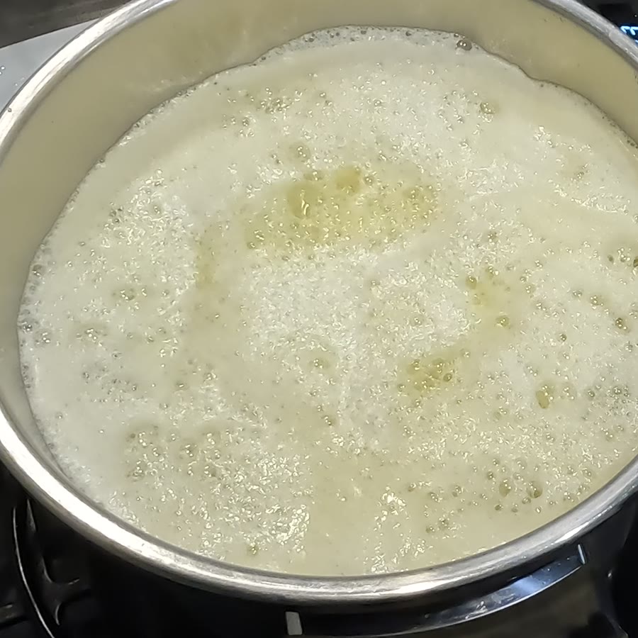 The pot full of loud white foam as the water boils out of the butter.